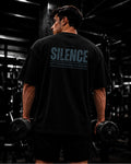 Polo oversize gym con frase "SILENCE | RESULTS SPEAK"